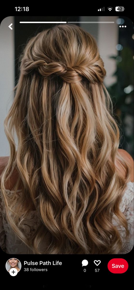 the back of a woman's head with long wavy hair and braid in it