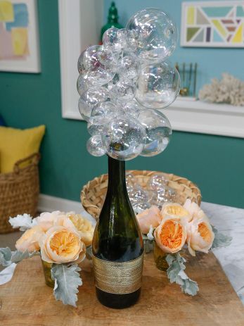 a vase filled with bubbles sitting on top of a wooden table