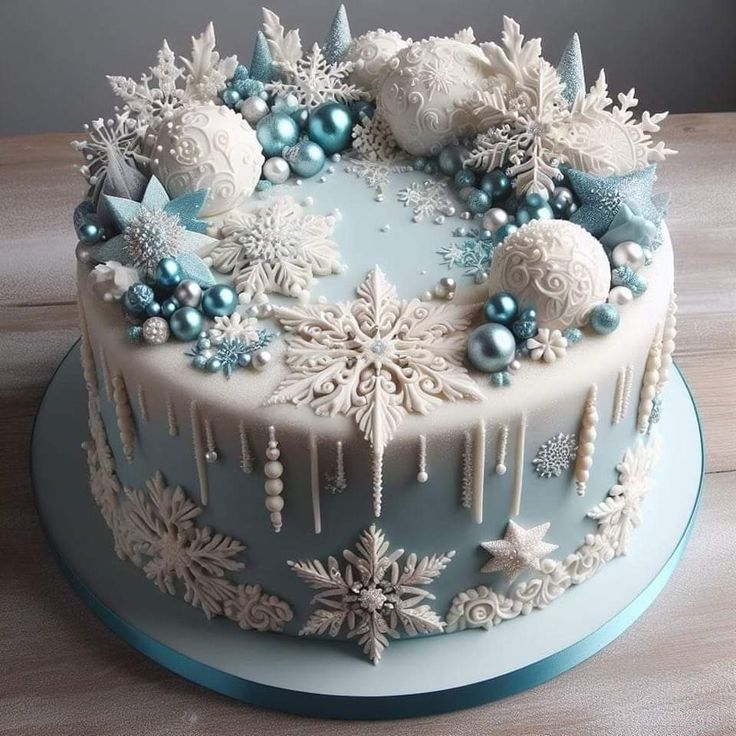 a frosted cake decorated with snowflakes and ornaments