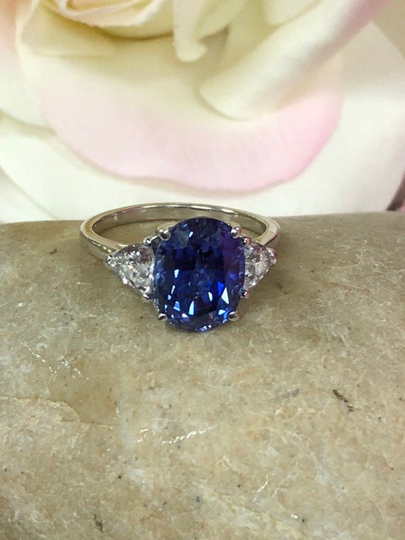 Oval ceylon blue sapphire and trillion accents 14k white gold | Etsy Fine Jewelry Sapphire Heart Cut Ring, Heart Cut Sapphire Ring In Fine Jewelry Style, Heart Cut Sapphire Ring Fine Jewelry, Classic Sapphire Gemstones With Accent Stones, Round Sapphire Gemstones For Anniversary, Blue Sapphire Heart Cut Ring, Blue Sapphire Ring With Pear-shaped Center Stone, Blue Heart Cut Sapphire Gemstone Ring, Blue Sapphire Ring With Three Stones