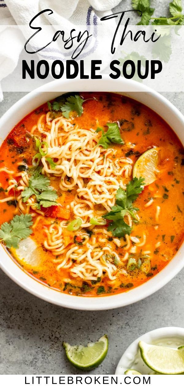 a bowl of noodle soup with limes and cilantro on the side