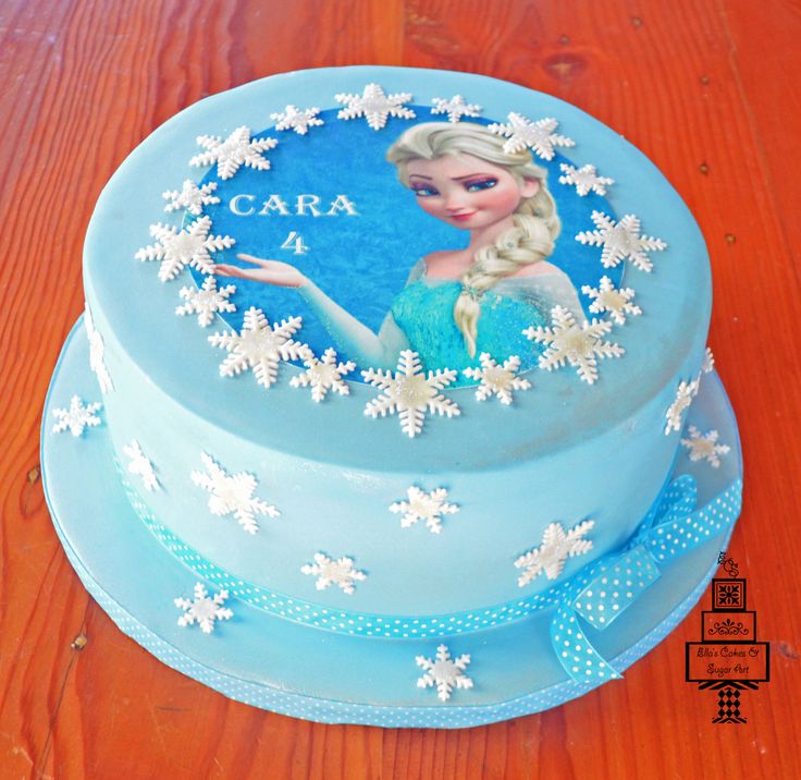 a frozen princess cake on a wooden table