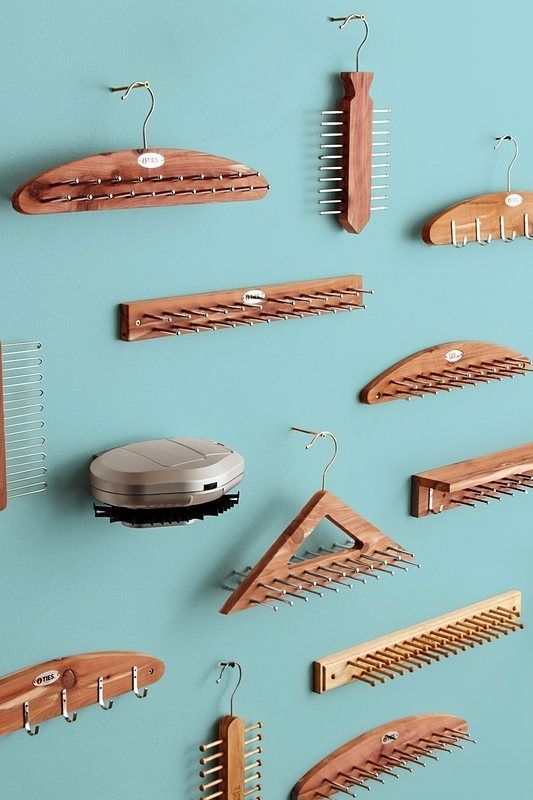 a collection of wooden combs and hair clips on a blue background with a silver object in the middle