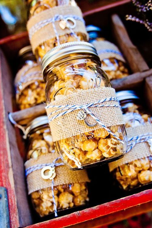 jars filled with popcorn sitting on top of a table