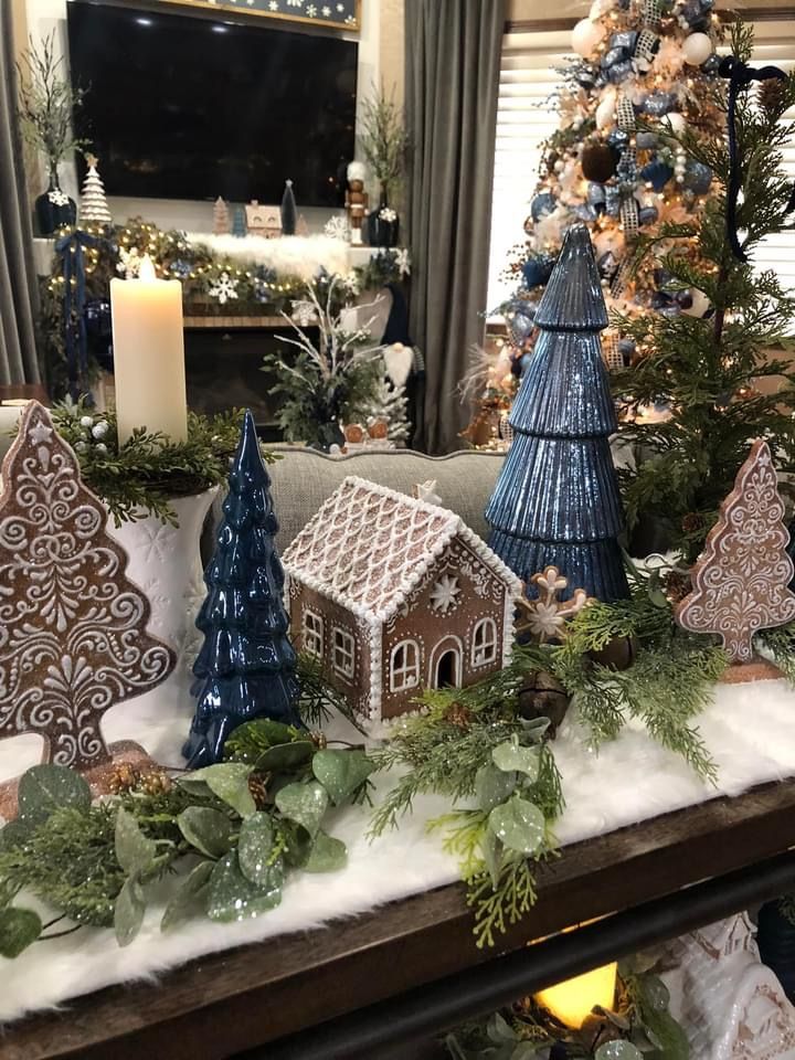 a fireplace mantle decorated with christmas decorations and trees