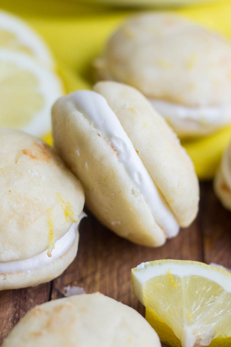 lemon cookies with icing and sliced lemons on a wooden table next to bananas