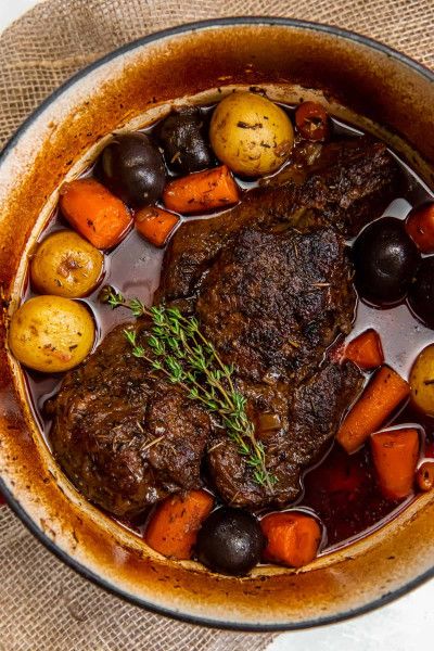 a pot filled with meat and vegetables on top of a table