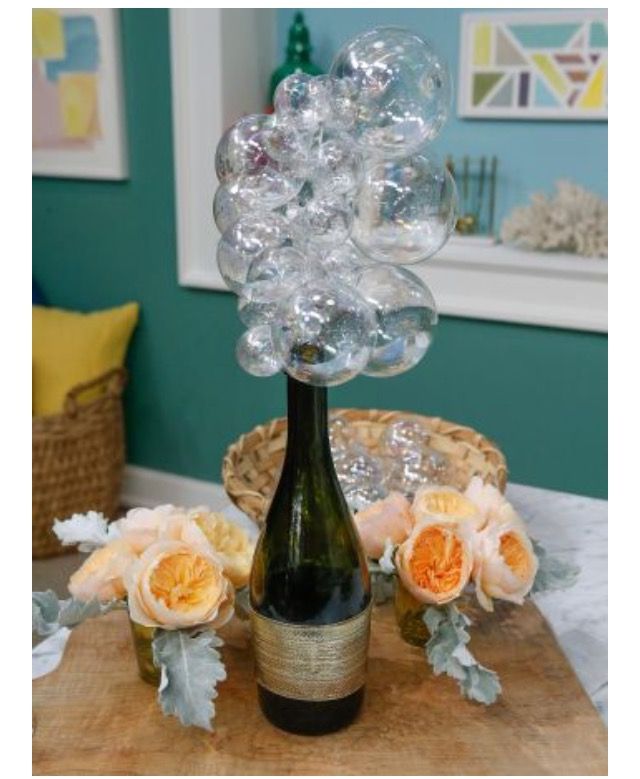 a vase filled with bubbles sitting on top of a wooden table