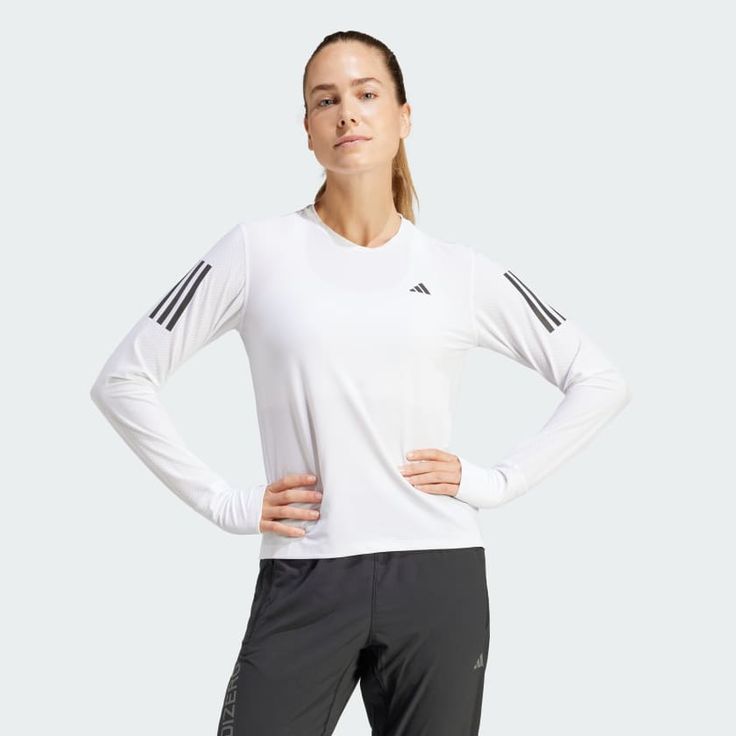 a woman is standing with her hands on her hips and wearing adidas running clothing