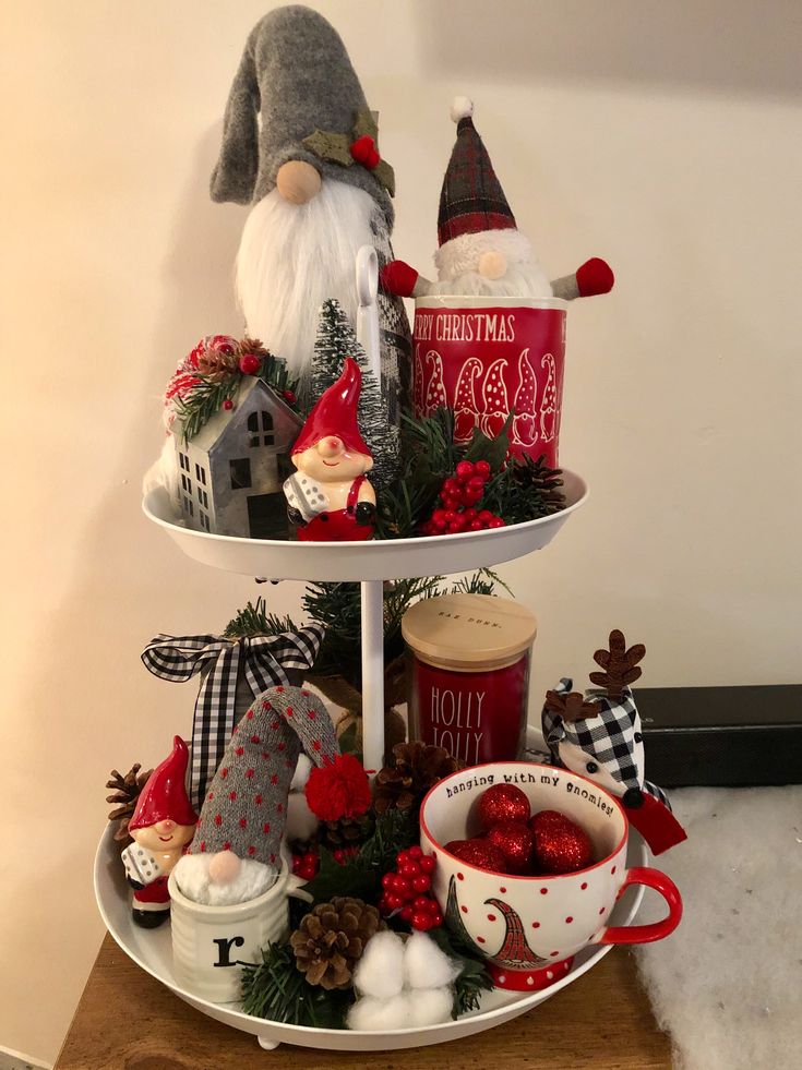 three tiered tray with christmas decorations and gnome figurines