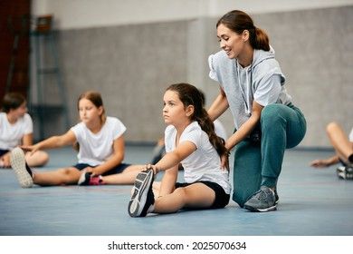 a group of young women sitting on the floor