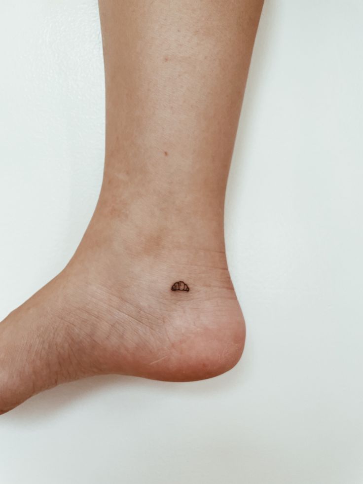 a person's foot with a tiny dot on it and a small circle in the middle