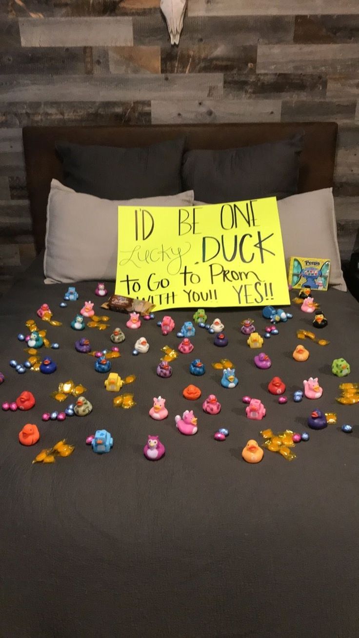 a bed topped with lots of colorful buttons next to a sign that says i'd be on duck