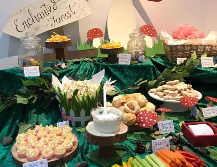 a table topped with lots of different types of foods and desserts next to each other