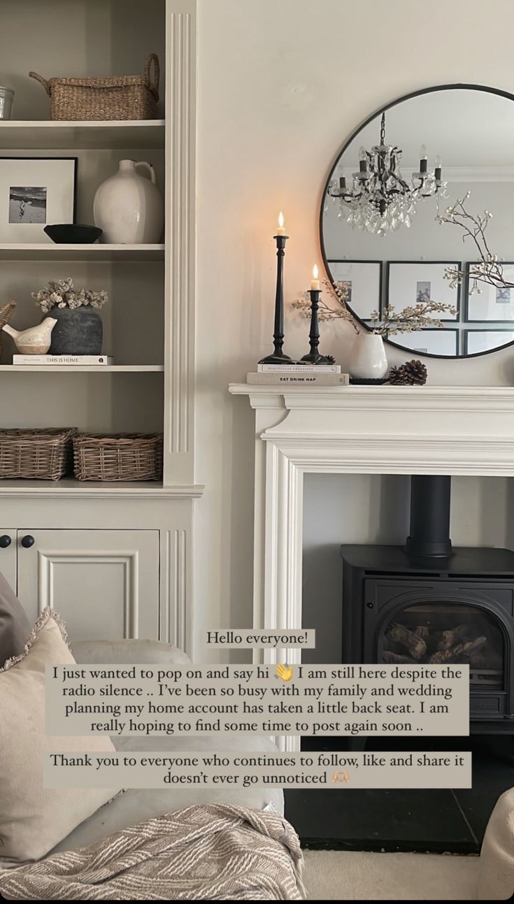 a living room filled with furniture and a fire place next to a mirror on the wall