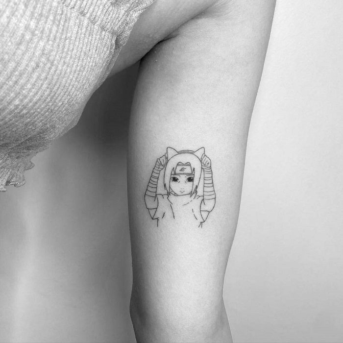 a woman's arm with a tattoo on it that has an image of a cat