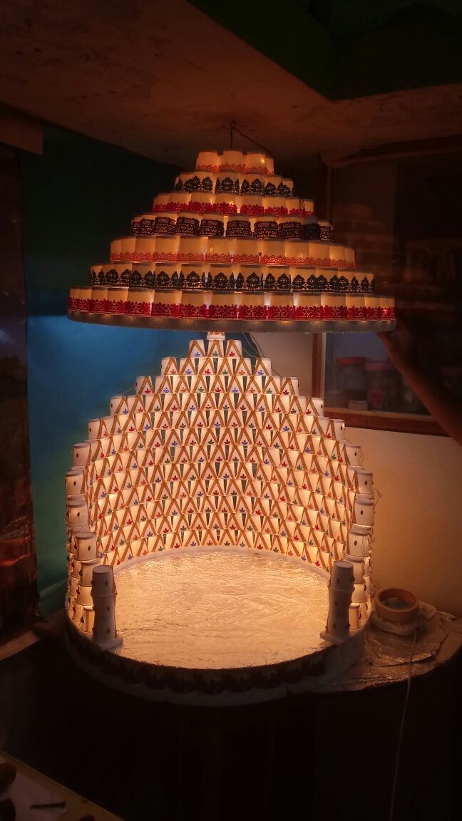 a lit up cake sitting on top of a table