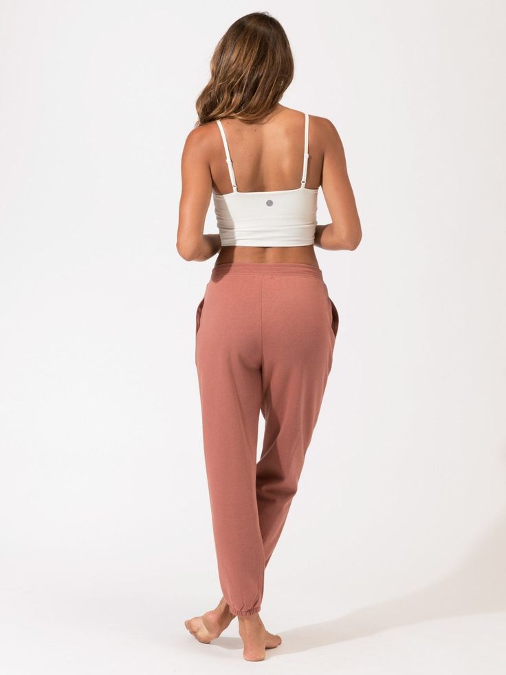 A boyfriend jogger made with our ultra soft Invincible fabric. Stain-resistant, quick-drying, sweat-proof, odor-free, and nano free technology makes this fleece jogger truly revolutionary. Designed with side pockets and a mid rise elastic waist band. Yoga Sportswear Sweatpants With Elastic Waistband, Sportswear Yoga Sweatpants With Elastic Waistband, Sportswear Sweatpants With Elastic Waistband For Yoga, Sporty Yoga Sweatpants With Elastic Waistband, Sporty Sweatpants With Elastic Waistband For Yoga, Yoga Athleisure Joggers, Sporty Loose Fit Joggers For Yoga, Sporty Yoga Joggers With Loosely Fitted Hips, Athleisure Style Yoga Sweatpants With Elastic Waistband