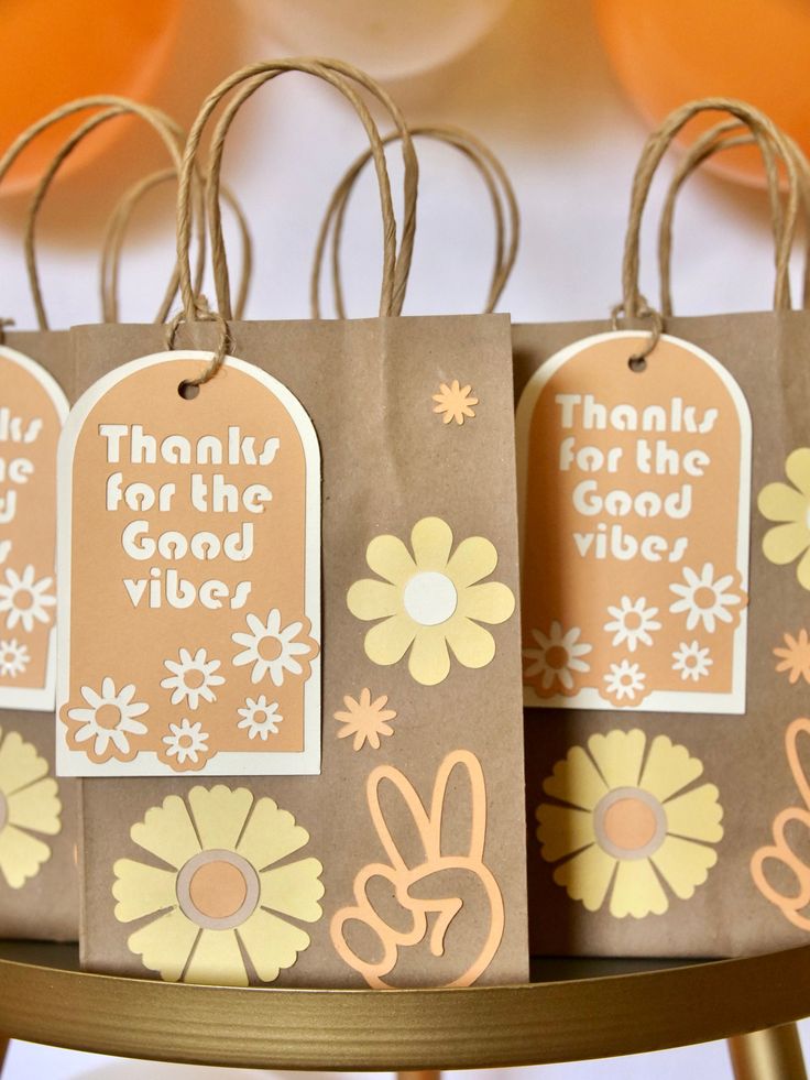 three brown bags with thank you for the good vibes tags hanging from each bag