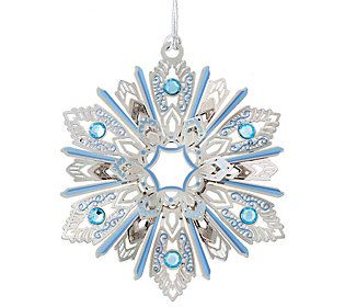 a snowflake ornament with blue and silver accents on a white background