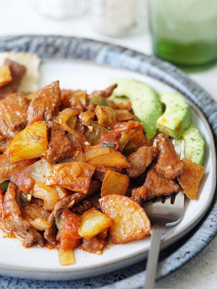 a close up of a plate of food with broccoli and meat on it