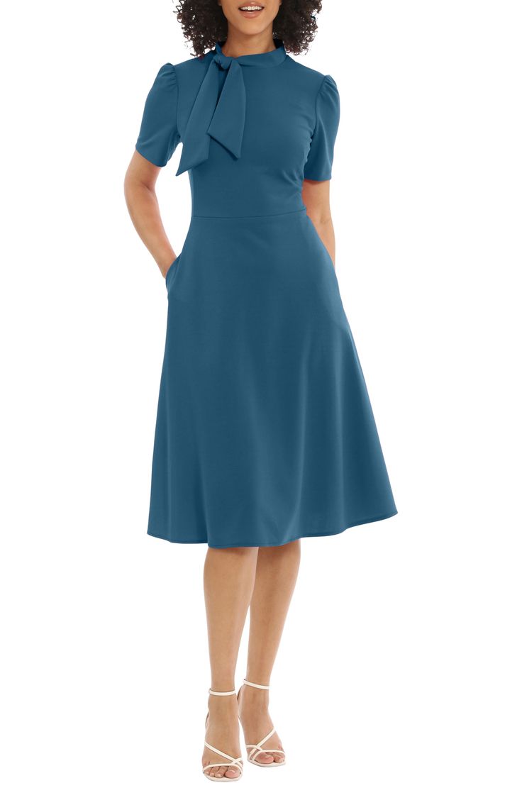 This dainty short sleeve dress is a retro inspired staple that's perfect for any well-dressed occasion. 45" length Necktie Short sleeves Back zip closure Lined 96% polyester, 4% spandex Hand wash, dry flat Imported Model stats: 5'10" height, 32" bust, 25" waist, 36" hip. Model is wearing size 2. Classic Short Sleeve Party Dress, Fitted Knee-length Midi Dress With Bow, Fitted Midi Dress With Bow, Knee-length, Fitted A-line Midi Dress With Bow, Fitted Midi Dress With Bow, Short Sleeve Midi Dress With Bow For Spring, Fitted Midi Dress With Short Sleeves For Semi-formal, Fitted Midi Dress With Short Sleeves For Semi-formal Occasions, Elegant Mid-length Short Sleeve Dress For Work