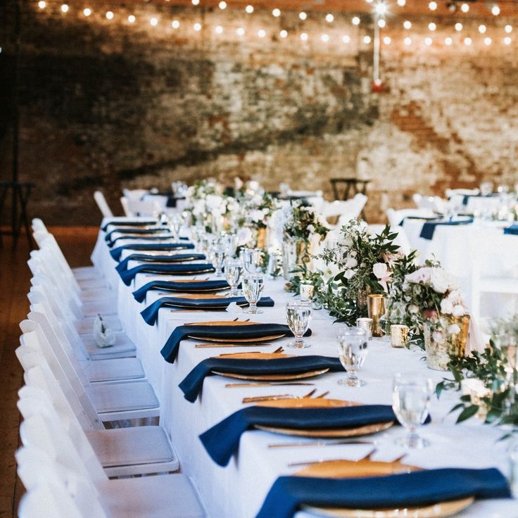 the tables are set with blue and white linens