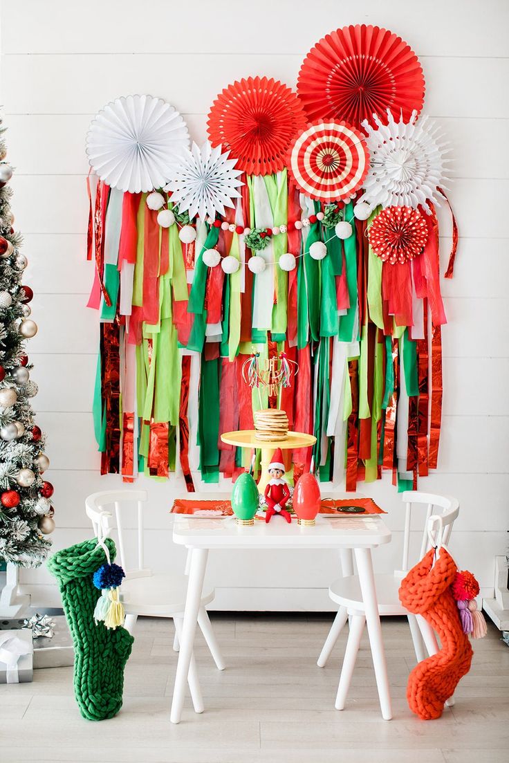 a table topped with lots of decorations next to a christmas tree