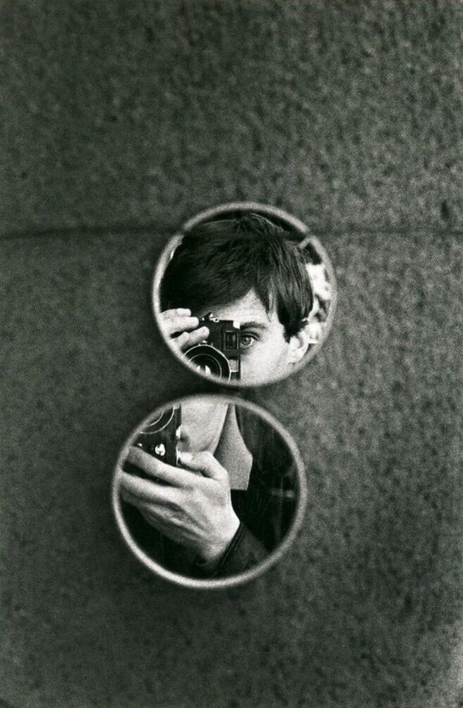 a person taking a photo in a mirror