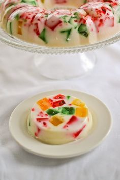 a white plate topped with a cake covered in gummy bears