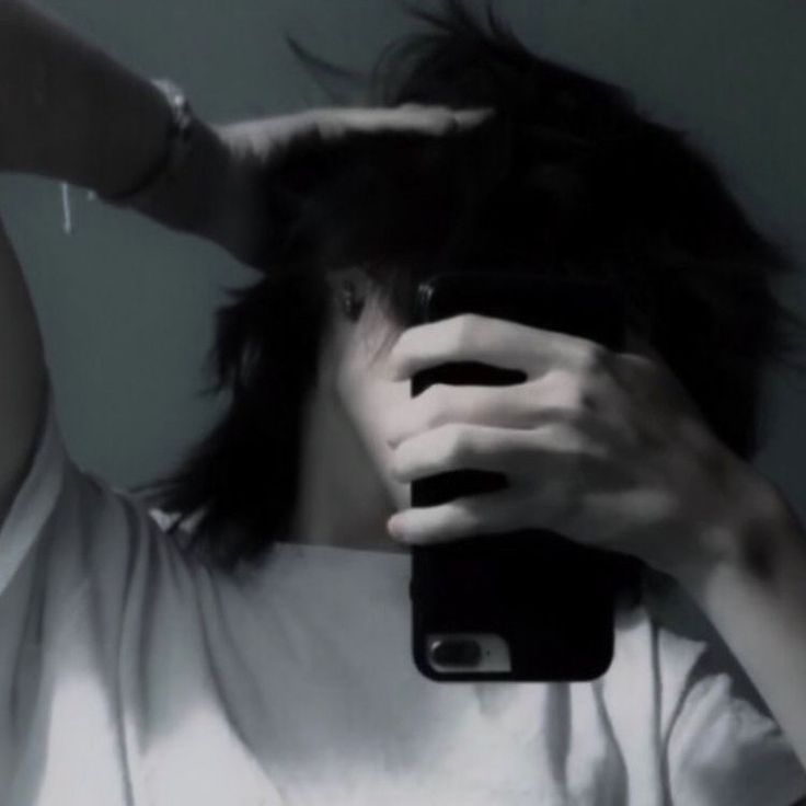 a person taking a selfie in front of a mirror with their cell phone up to their head