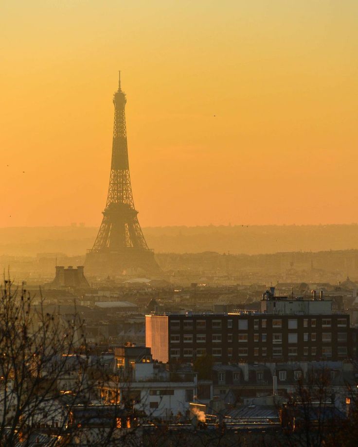 the eiffel tower towering over the city of paris, france at sunset or dawn