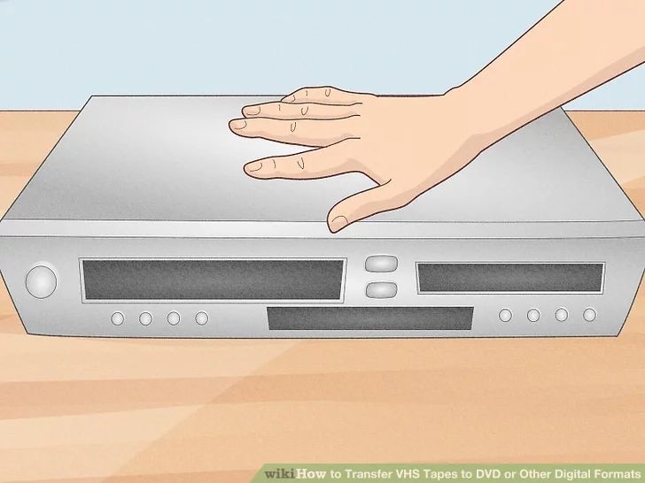 a hand on top of a silver electronic device