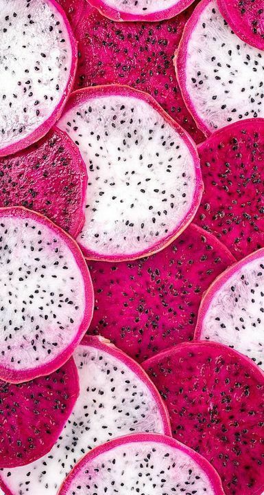 dragon fruit cut in half and placed on top of each other with black seeds all over them