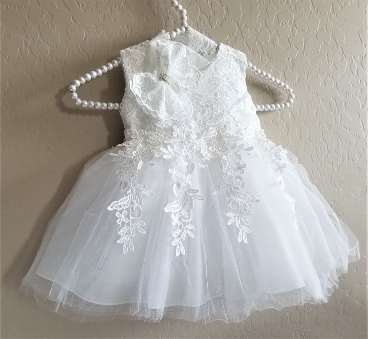 White Lace Dress With Lace Bodice For Ceremonies, White Sleeveless First Communion Dress With Lace Bodice, White Sleeveless Dress For Ceremony, Fitted Sleeveless Baptism Dress For Confirmation, White Sleeveless First Communion Dress With Lace Trim, White Baptism Dress For Party, Fitted Sleeveless Baptism Dress With Lace Bodice, White Lace Dress For Confirmation, Sleeveless White Lace Baptism Dress