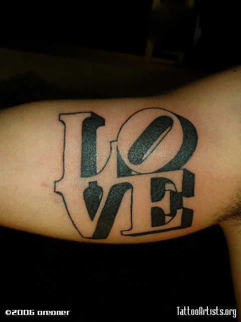 a man's arm with the word love written in black and white ink on it