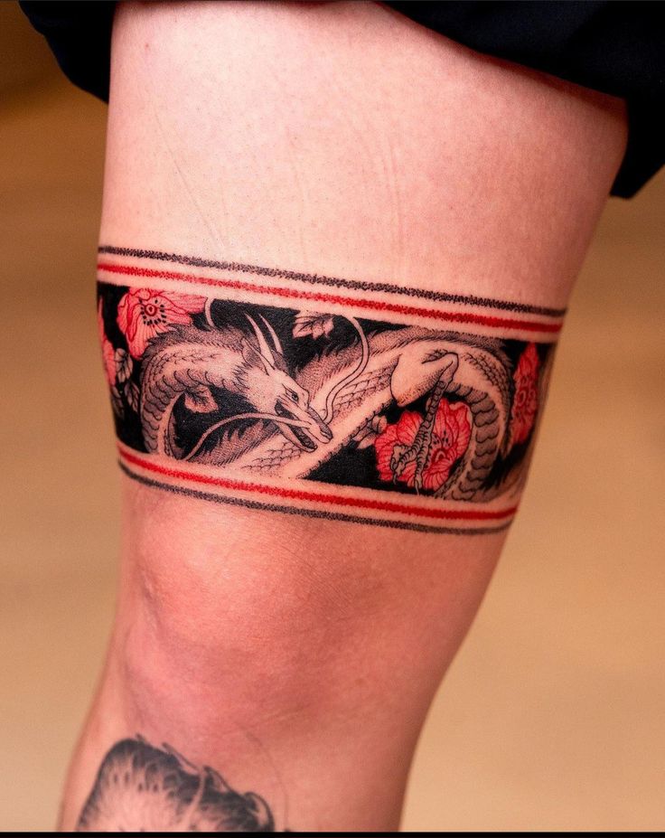 a woman's leg with a tattoo on it and a snake in the middle