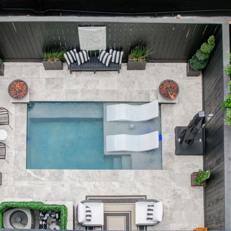 an aerial view of a pool and patio furniture