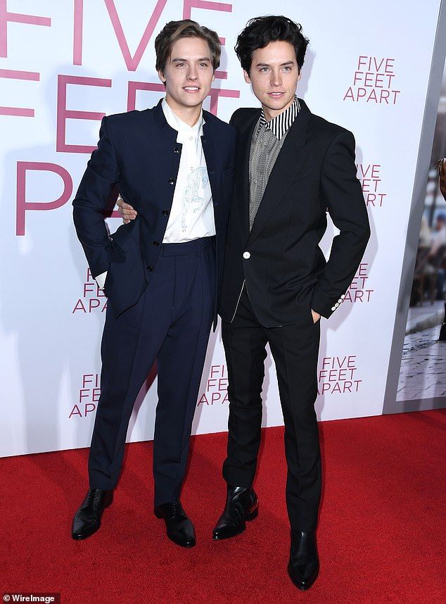 two young men standing next to each other on a red carpet at the five feet apart premiere