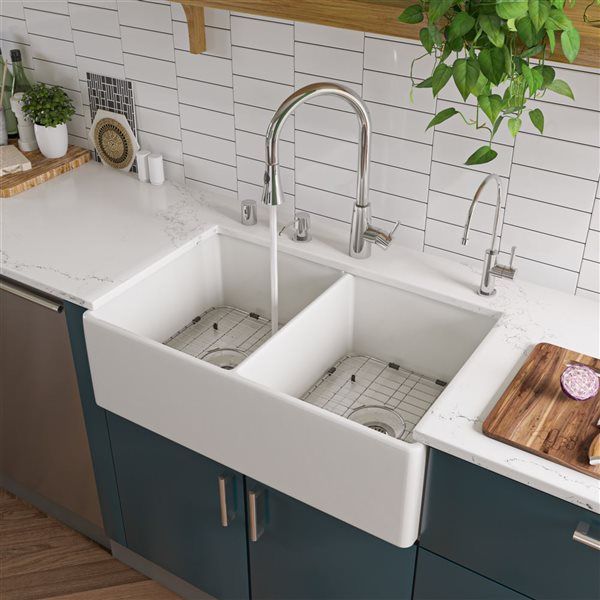 a kitchen with two sinks and a cutting board on the counter top next to it