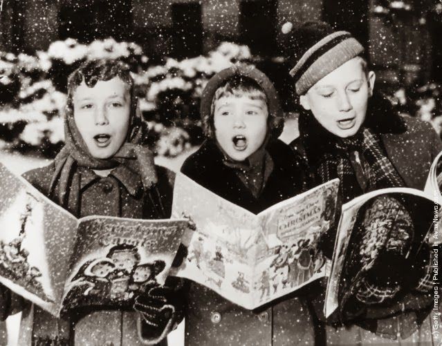 black and white photo of children singing in the snow