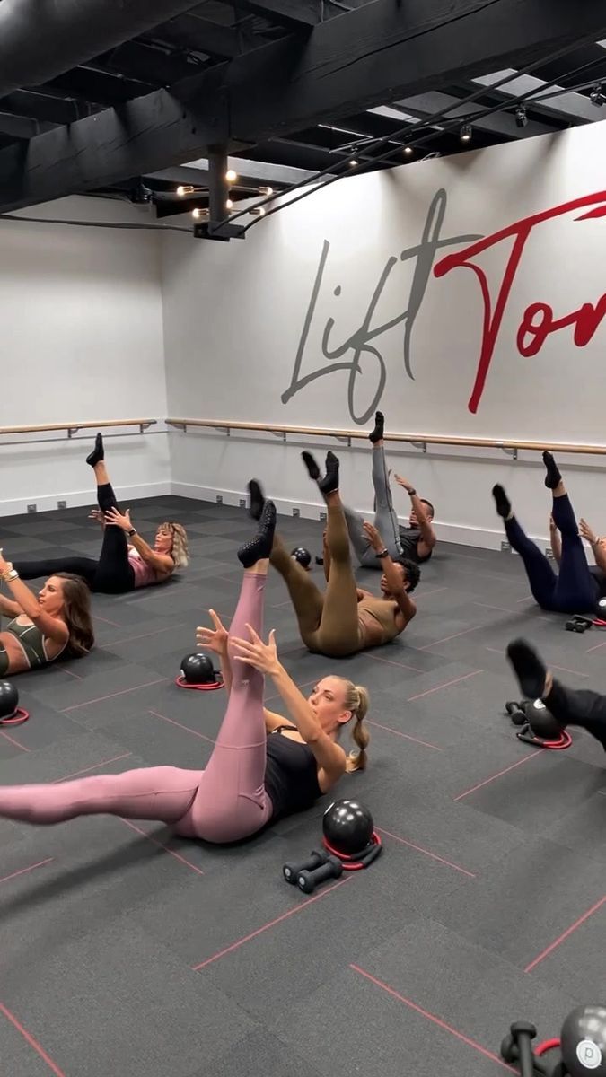 a group of people doing exercises in a gym