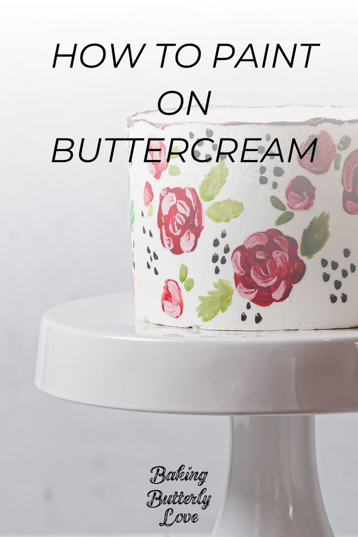 a white cake with red flowers on it and the words how to paint on buttercream