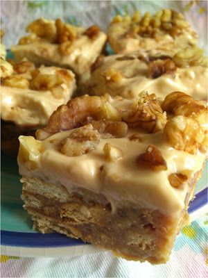 several pieces of cake on a plate with white frosting and walnuts in the middle