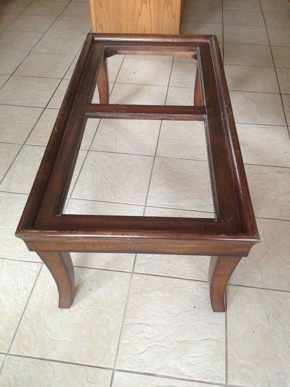 a wooden bench sitting on top of a tiled floor