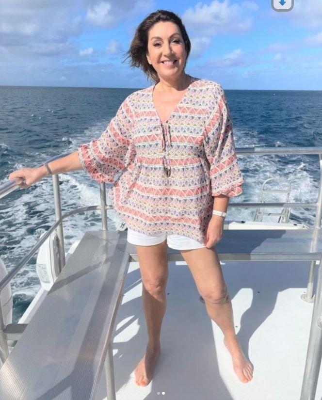 a woman standing on the deck of a boat