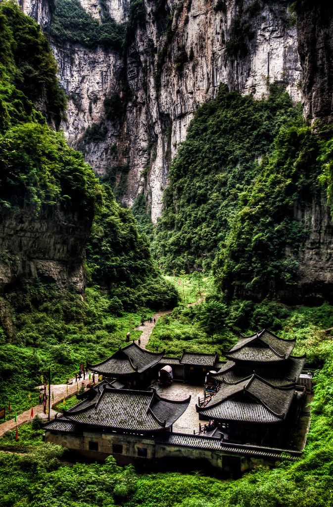 an old building in the middle of a lush green valley