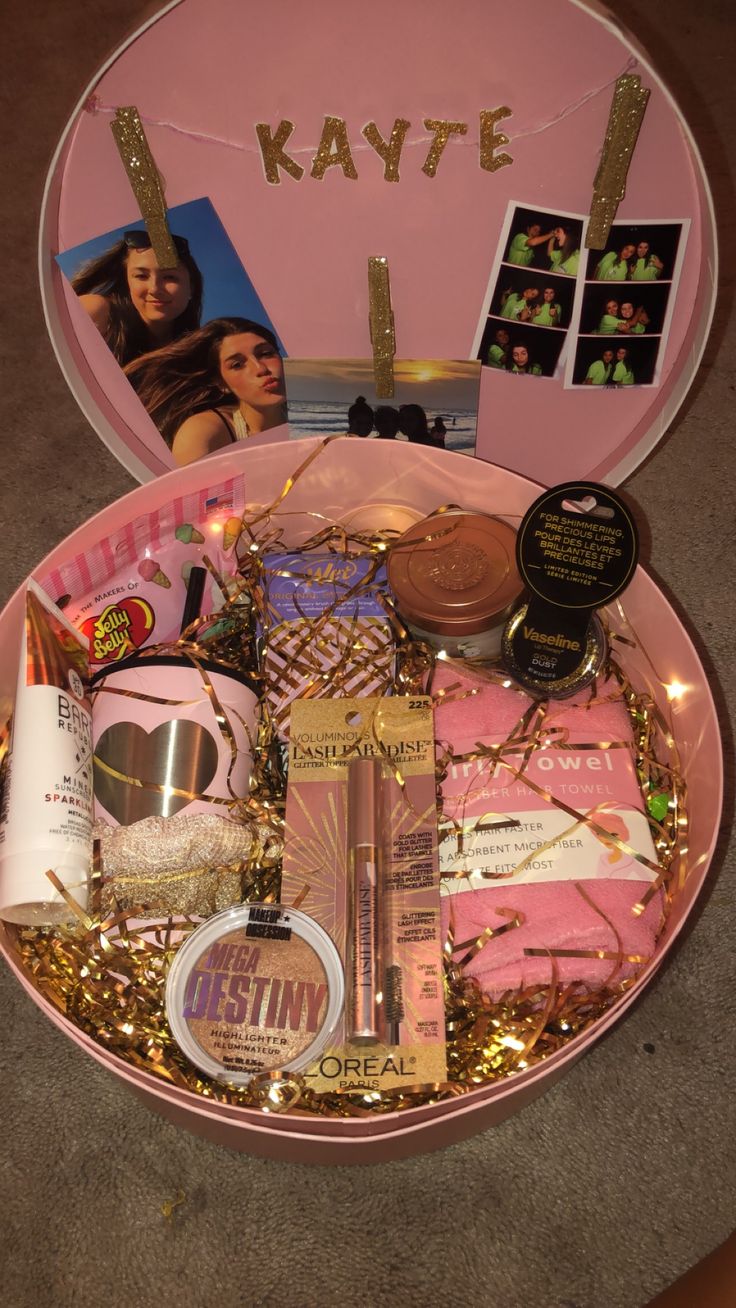 a pink box filled with personal items on top of a table