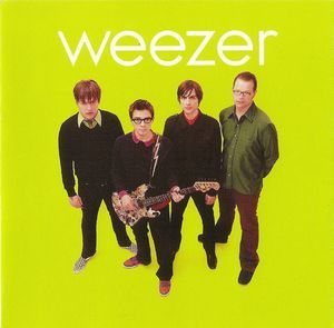 a group of men standing next to each other in front of a green background with the words weezer on it