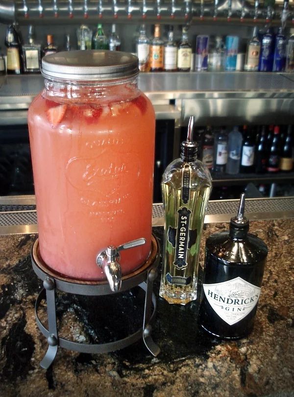 a large jar filled with liquid sitting on top of a counter next to a bottle